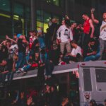 Fans Protesting Standing On Bus