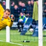 Goalkeeper in Yellow Saving The Ball