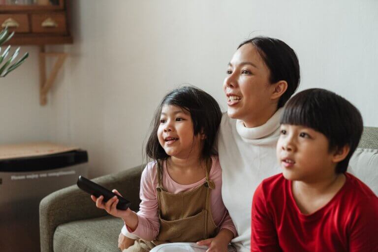 Child With Remote Sitting With Family