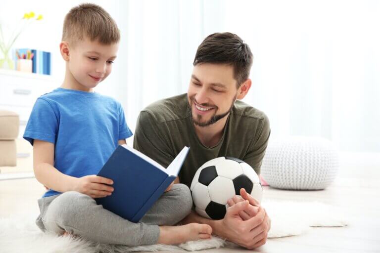 Best Children’s Football Books In 2021 Father Helping Son Read Whilst Holding Football