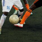 Defender Tackling The Attacker at Football